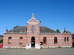 Scène urbaine avec un bâtiment traditionnel et rues pavées à Quévy, montrant notre service de débouchage local rapide.